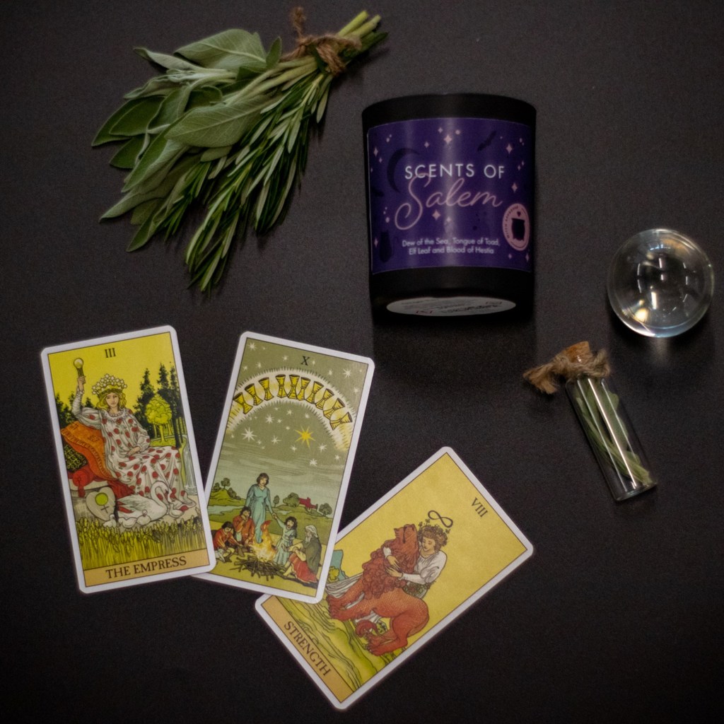 Tarot cards next to scents of salem candle