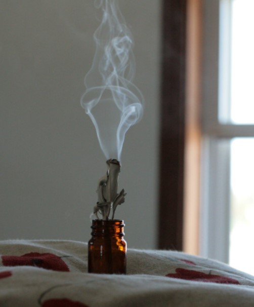Smoke cleanse happening in a room with garden sage